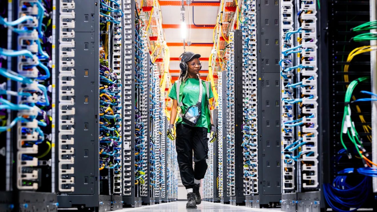 A Markley worker walking the aisle of a data hall
